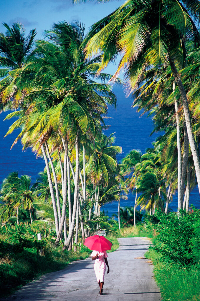 Woman with parasol walking in Barbados
