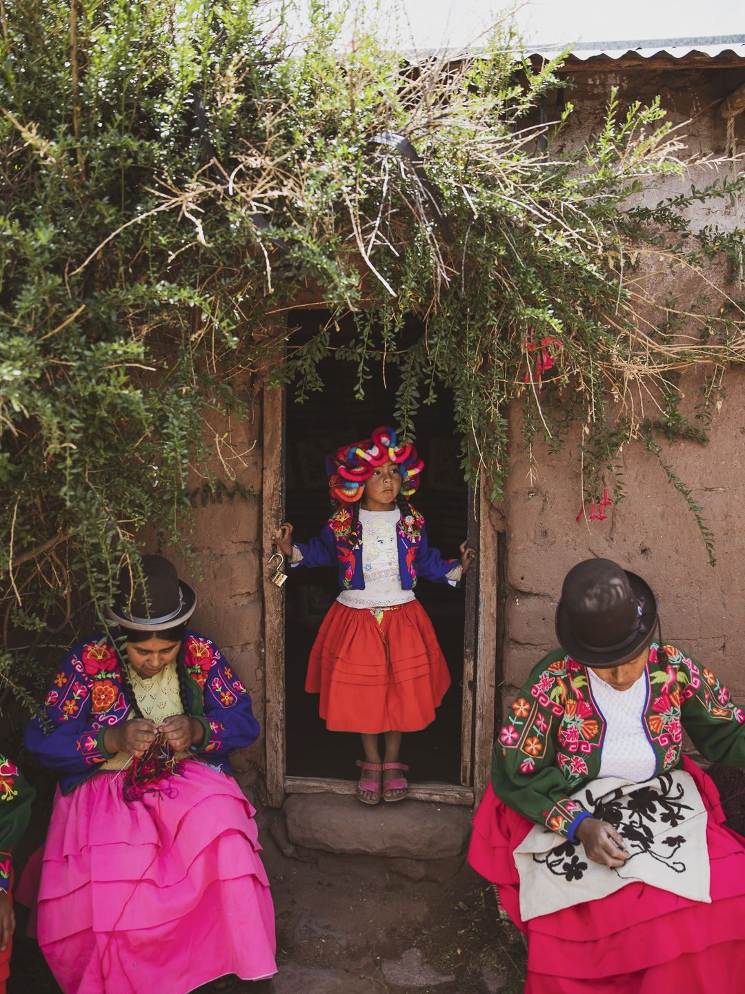 Titilaka children & local women embroidering in traditional dress