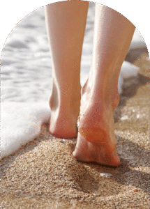 Barefoot on the beach arch walking in the surf