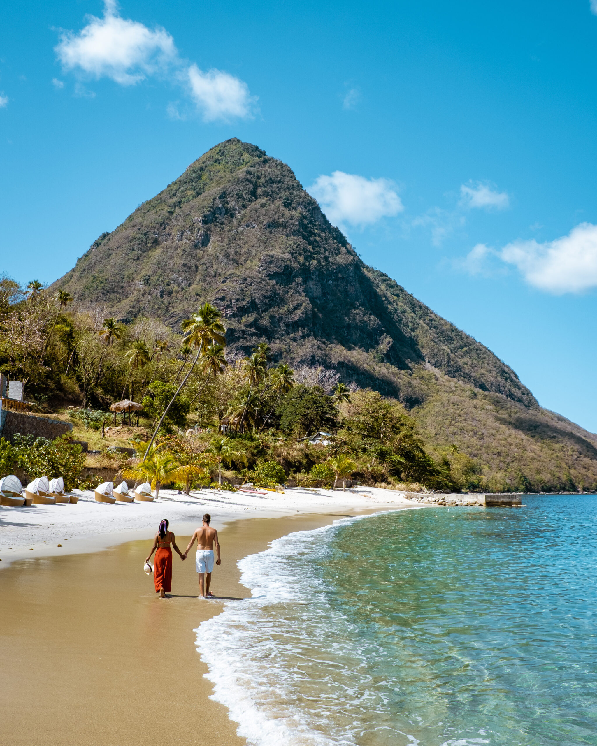 couple on luxury vacation in St Lucia, men and woman walking on the beach Saint Lucia